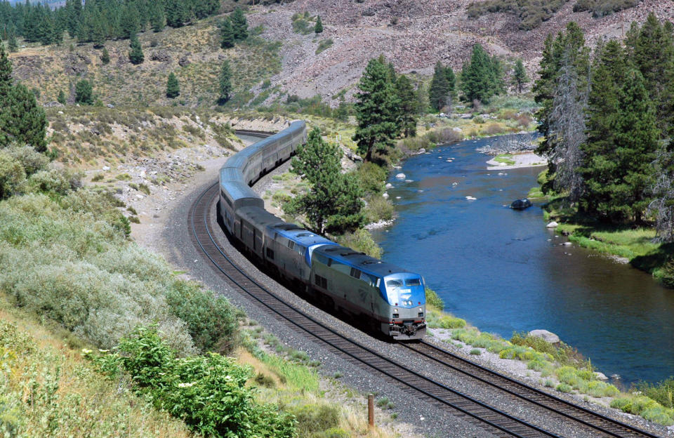 This undated image provided by Amtrak shows the California Zephyr train near Truckee, Calif. The California Zephyr starts in Emeryville, Calif., near San Francisco, en route to Reno, Nev., a 236-mile journey that offers beautiful views as well as history. It crosses the Sierra Nevada mountain range and follows the same course as the historic Transcontinental Railroad, a 19th century engineering feat that bolstered the nation’s western expansion. The Zephyr’s ultimate destination is Chicago, a 51-hour trip from Emeryville. (AP Photo/Amtrak, Phil Gosney)