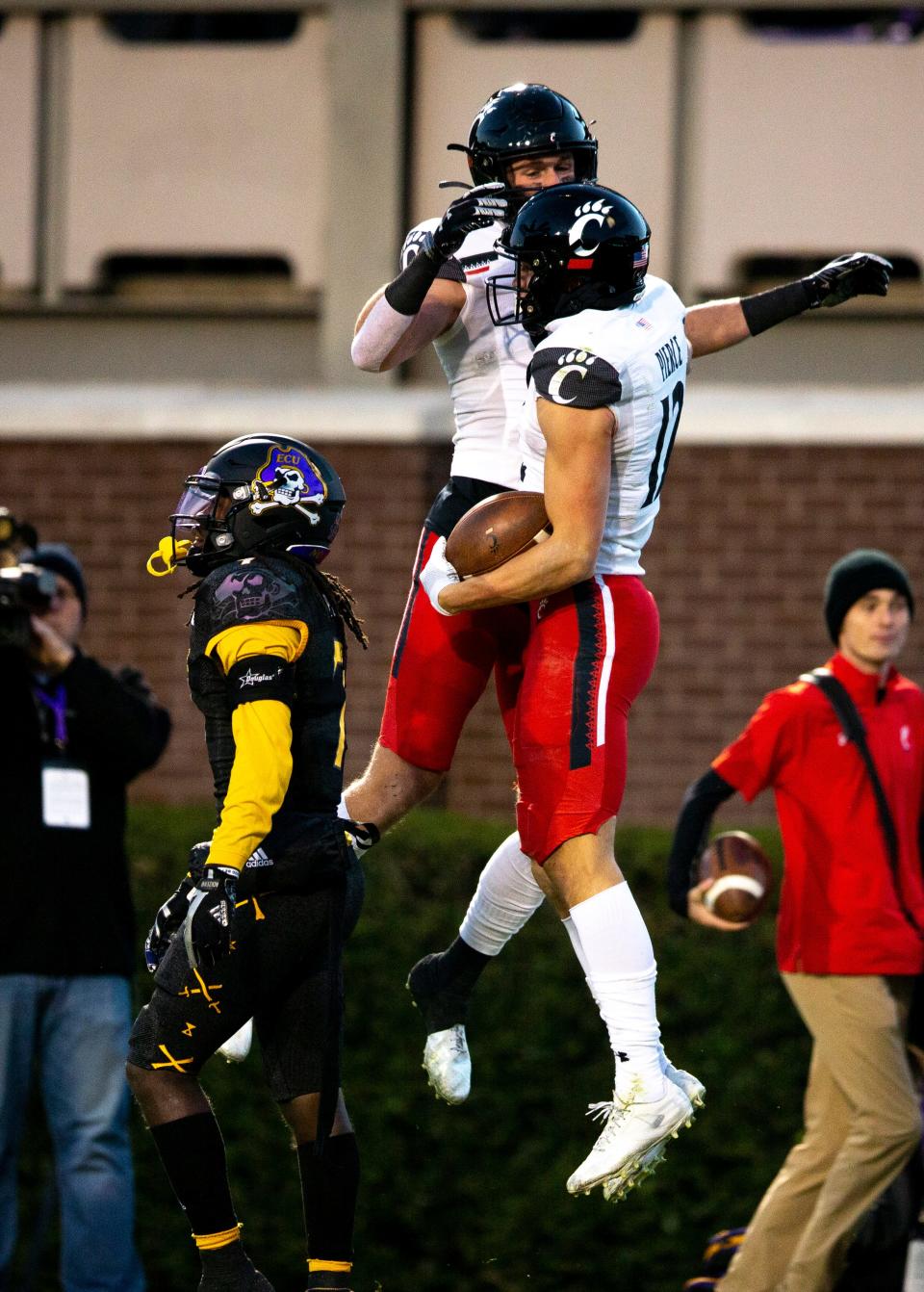 Cincinnati Bearcats wide receiver Alec Pierce (12) celebrates with Cincinnati Bearcats tight end Josh Whyle (81) after scoring a touchdown in the first half of the NCAA football game between the Cincinnati Bearcats and the East Carolina Pirates at Dowdy-Ficklen Stadium in Greenville, NC, on Friday, Nov. 26, 2021.