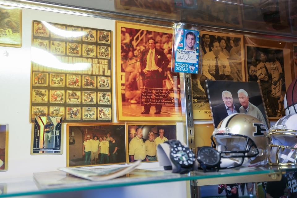 Signed photos and memorabilia sit inside of a case as people remove sports memorabilia from the case inside Bruno's Pizza after officially closing its doors, on Thursday, Feb. 9, 2024, in West Lafayette Ind.