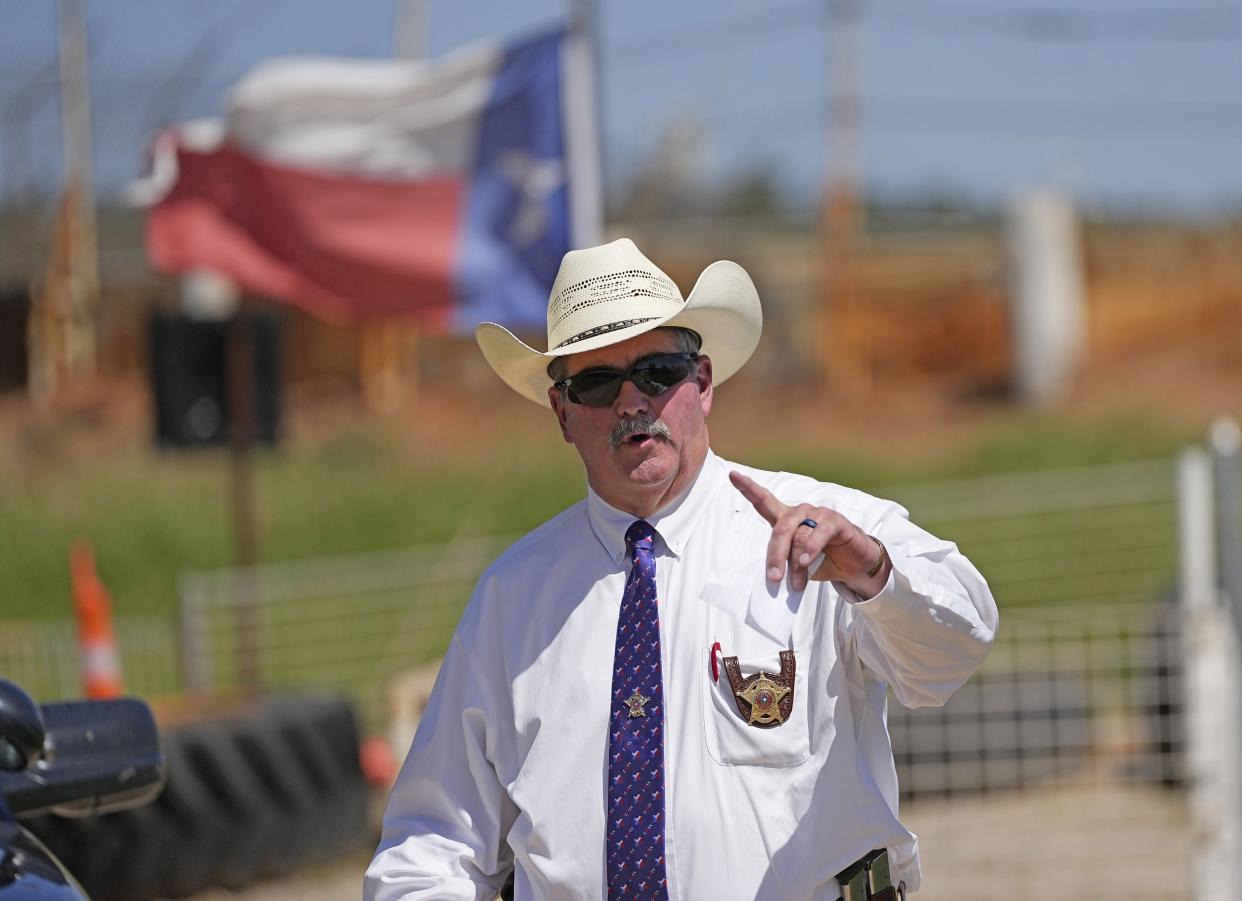 San Jacinto County Sheriff Greg Capers answers a question after a news conference, Sunday, April 30, 2023, in Cleveland, Texas. The search for a Texas man who allegedly shot his neighbors after they asked him to stop firing off rounds in his yard stretched into a second day Sunday, with authorities saying the man could be anywhere by now. The suspect fled after the shooting Friday night that left five people dead, including a young boy. (AP Photo/David J. Phillip)