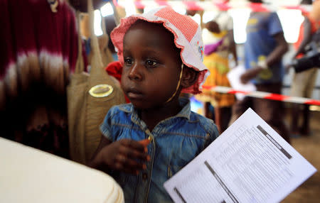 South Sudanese refugee girl displaced by fighting holds her immunization card on arrival at Imvepi settlement in Arua district, northern Uganda, April 4, 2017. Picture taken April 4, 2017. REUTERS/James Akena