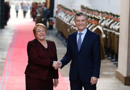 Chile's President Michelle Bachelet and Argentina's President Mauricio Macri shake hands at the Presidential House during Macri's official visit in Santiago, Chile June 27, 2017. REUTERS/Rodrigo Garrido