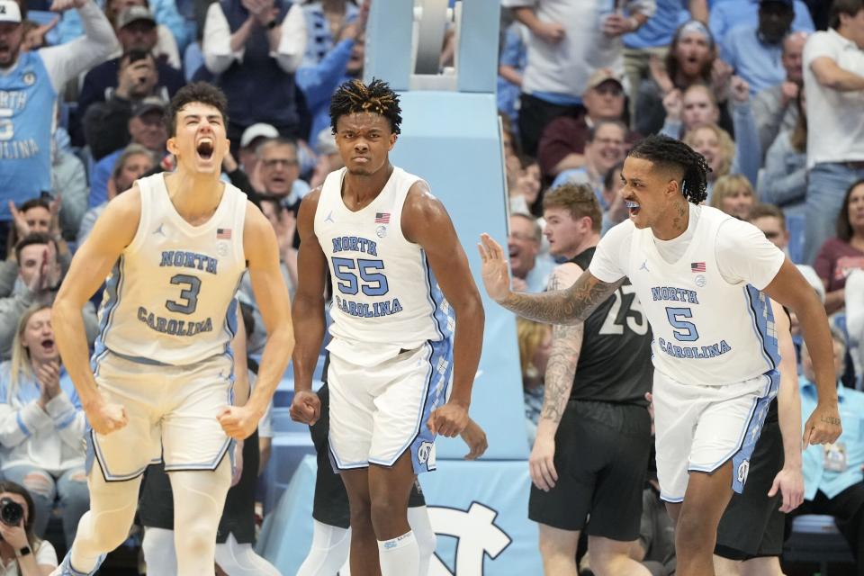 Feb 17, 2024; Chapel Hill, North Carolina, USA; North Carolina Tar Heels guard Cormac Ryan (3) and forwards Harrison Ingram (55) and Armando Bacot (5) react after Ingram scores in the first half at Dean E. Smith Center. Mandatory Credit: Bob Donnan-USA TODAY Sports