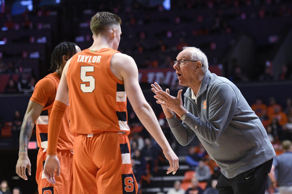 Syracuse coach Jim Boeheim, right, talks with Justin Taylor (5) and a teammate during the first half of an NCAA college basketball game against Illinois, Tuesday, Nov. 29, 2022, in Champaign, Ill. (AP Photo/Michael Allio)