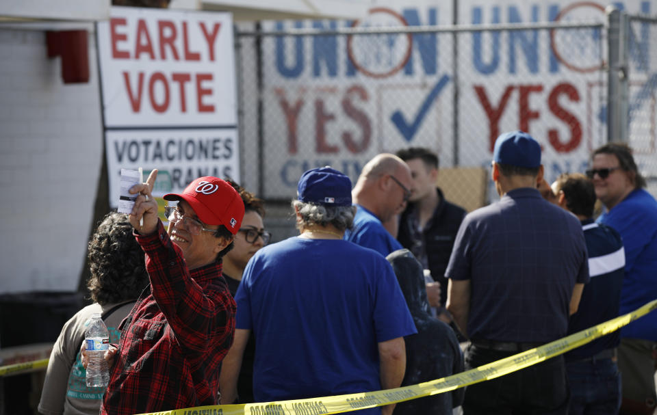 People wait in line to vote early at the Culinary Workers union Monday, Feb. 17, 2020, in Las Vegas. (AP Photo/John Locher)