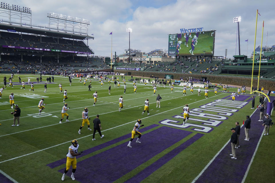 Iowa football players warm up before an NCAA college football game against Northwestern, Saturday, Nov. 4, 2023, at Wrigley Field in Chicago. (AP Photo/Erin Hooley)