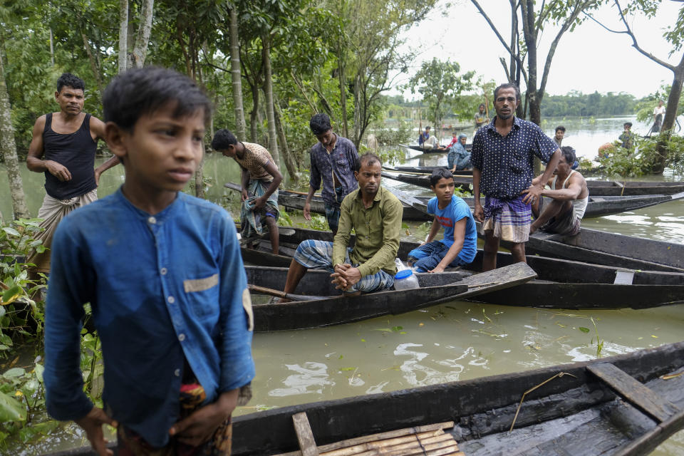 Flood affected people wait to receive relief material in Sylhet, Bangladesh, Wednesday, June 22, 2022. (AP Photo/Mahmud Hossain Opu)