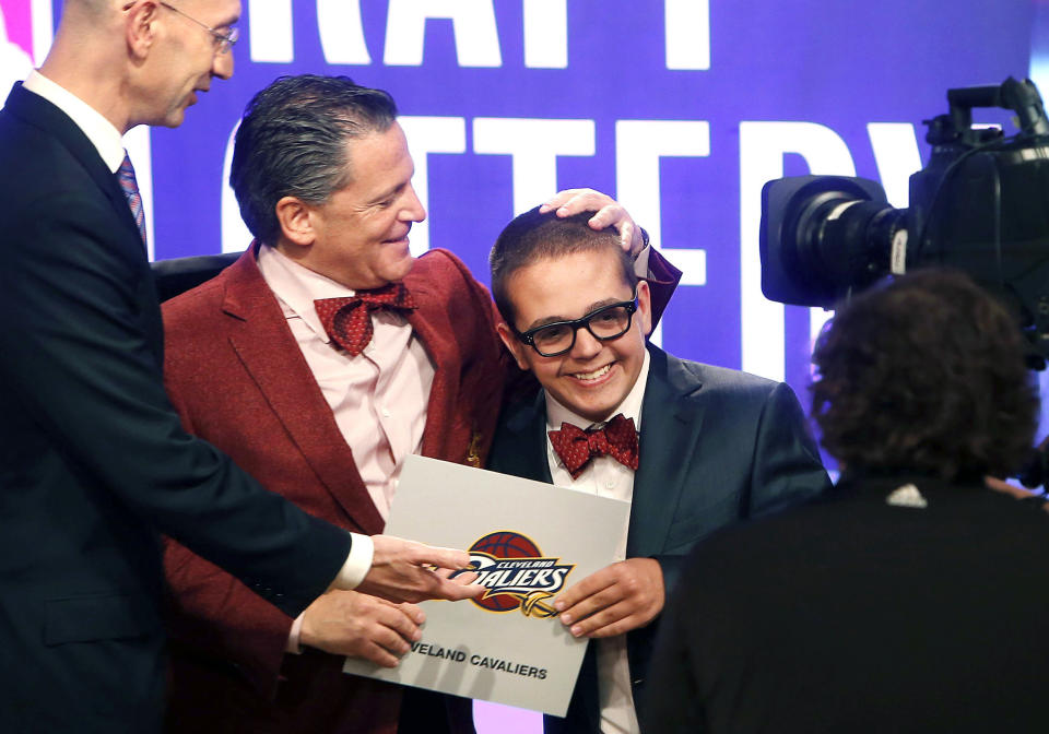 FILE – In this May 21, 2013, file photo, Cleveland Cavaliers owner Dan Gilbert congratulates his son, Nick Gilbert, after the team won the NBA basketball draft lottery in New York. Nick Gilbert underwent major brain surgery this week. A team spokesman said the 21-year-old will have the operation in Detroit. (AP Photo/Jason DeCrow, File)