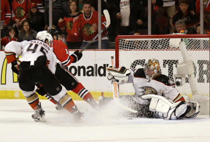 Ducks goalie Frederik Andersen stops a shot by Chicago's Patrick Sharp during overtime in Game 4. (AP)