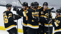 Boston Bruins center Craig Smith, second from left, celebrates after scoring the game-winning goal against the Pittsburgh Penguins during an overtime period of an NHL hockey game, Tuesday, Jan. 26, 2021, in Boston. The Bruins won 3-2. (AP Photo/Charles Krupa)