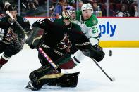 Arizona Coyotes goaltender Scott Wedgewood (31) makes a save on a shot by Dallas Stars left wing Jason Robertson (21) as Coyotes defenseman Dysin Mayo, left, looks on during the second period of an NHL hockey game Sunday, Feb. 20, 2022, in Glendale, Ariz. (AP Photo/Ross D. Franklin)