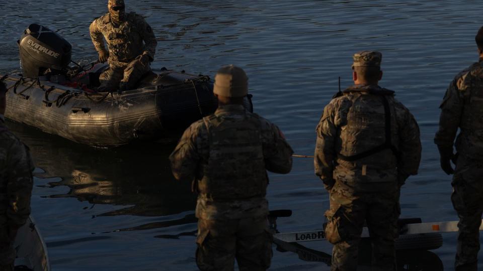Texas National Guard members load a raft to a pickup at the bank of the Rio Grand at Shelby Park in Eagle Pass, on Jan. 16, 2024. Texas has closed off Shelby Park, cutting access to federal agents to part of the Texas-Mexico border and escalating tensions between the Biden administration and Gov. Greg Abbott. (Eddie Gaspar/The Texas Tribune)