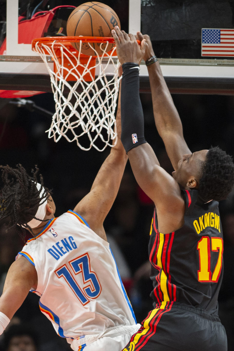 Atlanta Hawks forward Onyeka Okongwu dunks over Oklahoma City Thunder forward Ousmane Dieng during the first half of an NBA basketball game, Monday, Dec. 5, 2022, in Atlanta. (AP Photo/Hakim Wright Sr.)