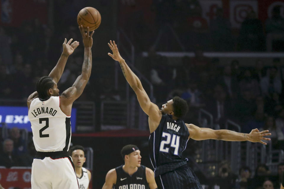 Los Angeles Clippers forward Kawhi Leonard, left, shoots over Orlando Magic center Khem Birch during the first half of an NBA basketball game in Los Angeles, Thursday, Jan. 16, 2020. (AP Photo/Chris Carlson)