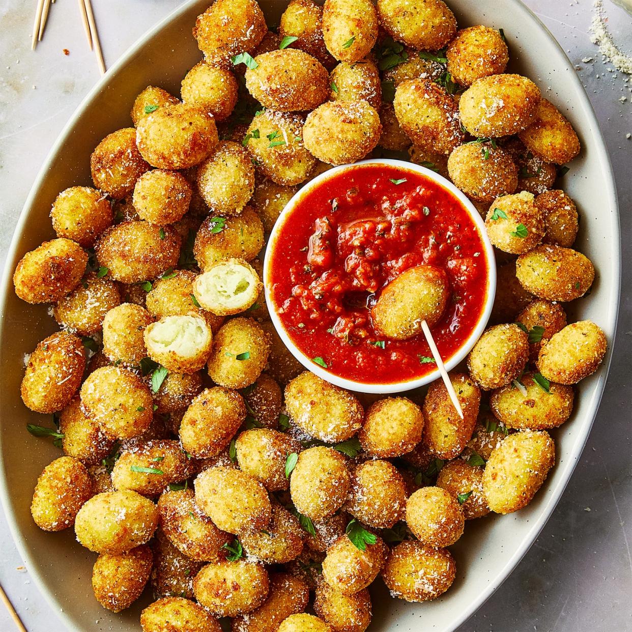 fried gnocchi bites in a bowl with marinara sauce on the side