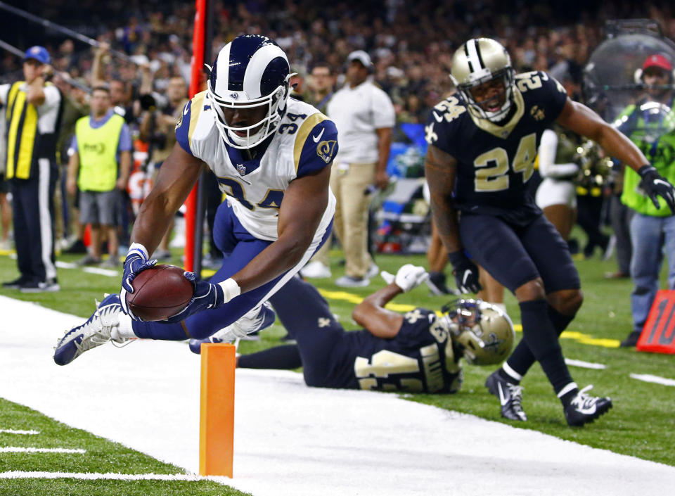 Los Angeles Rams running back Malcolm Brown (34) scores a touchdown in front of New Orleans Saints free safety Marcus Williams (43) and strong safety Vonn Bell (24) in the second half of an NFL football game in New Orleans, Sunday, Nov. 4, 2018. (AP Photo/Butch Dill)