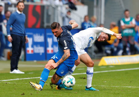 Soccer Football - Bundesliga - TSG 1899 Hoffenheim vs Schalke 04 - Rhein-Neckar-Arena, Hoffenheim, Germany - September 23, 2017 Hoffenheim’s Steven Zuber in action with Schalke’s Amine Harit REUTERS/Michaela Rehle