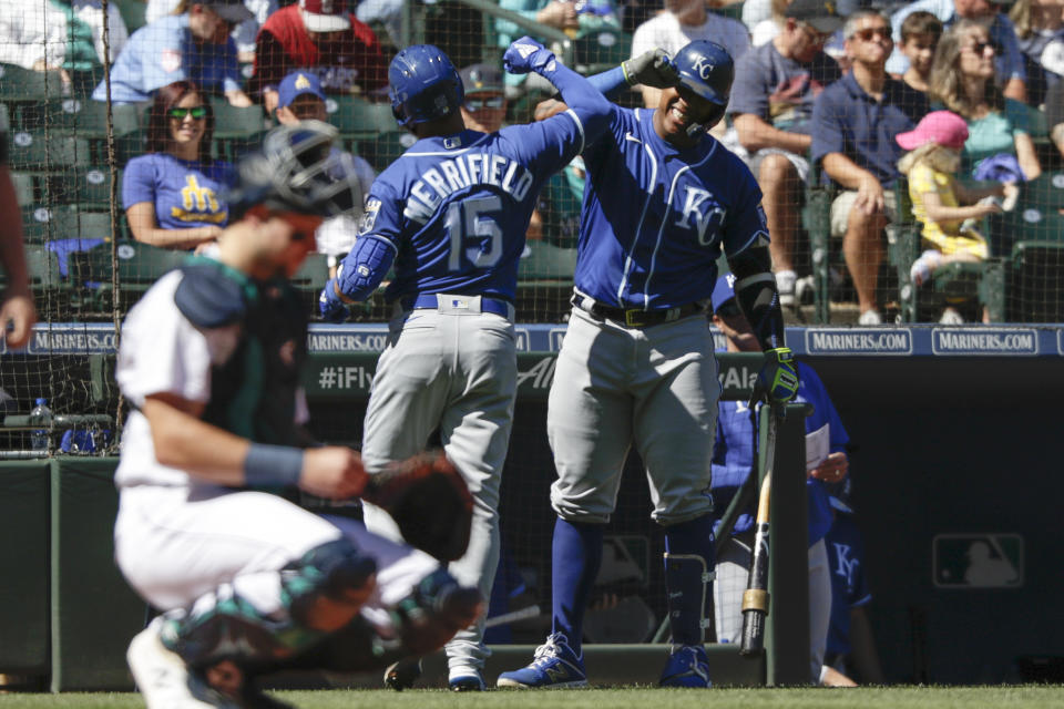 Kansas City Royals' Whit Merrifield celebrates with teammate Salvador Perez after Merrifield's solo home run during the first inning of a baseball game against the Seattle Mariners, Saturday, Aug. 28, 2021, in Seattle. (AP Photo/Jason Redmond)