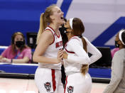 North Carolina State's Elissa Cunane, left, celebrates with Jakia Brown-Turner (11) after North Carolina State's victory over Virginia Tech in an NCAA college basketball game in the quarterfinals of the Atlantic Coast Conference women's tournament Friday, March 5, 2021, in Greensboro, N.C. (Ethan Hyman/The News & Observer via AP)