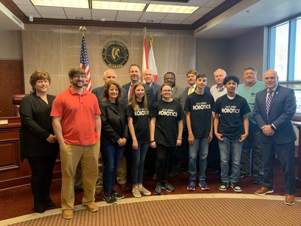 Etowah County Commissioners alongside Etowah County Schools Superintendent Dr. Alan Cosby and members of the Etowah County School Board and the Duck Springs Elementary School robotics team.