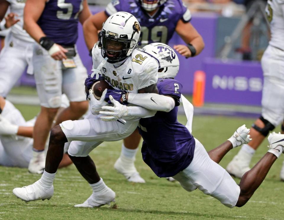 Colorado’s Travis Hunter is brought down byTCU corner back Josh Newton (2) the first half of a NCAA football game at Amon G. Carter Stadium in Fort Worth,Texas, Saturday Sept. 02, 2023. Colorado led 17-14 at the half. (Special to the Star-Telegram Bob Booth)