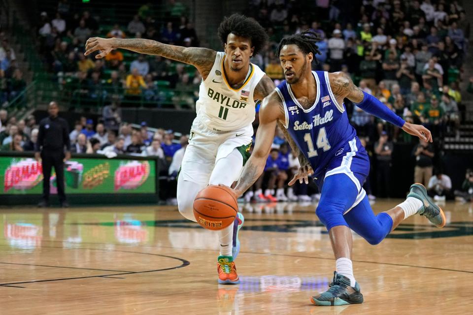 Seton Hall guard Dre Davis (14) works to the basket as Baylor forward Jalen Bridges (11) defends in the first half of an NCAA college basketball game in Waco, Texas, Tuesday, Dec. 5, 2023. (AP Photo/Tony Gutierrez)