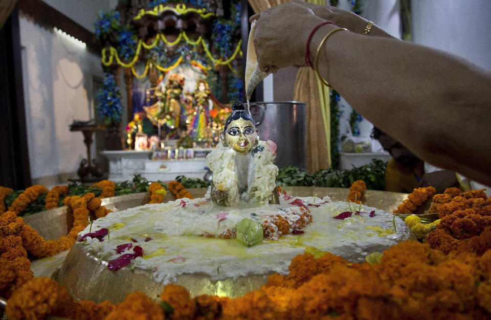 <p>A devotee pours milk on an idol of Hindu Lord Krishna during the Janmashtami festivities in Gauhati, India, Aug. 25, 2016. Janmashtami marks the birth of Lord Krishna. (Photo: Anupam Nath/AP) </p>