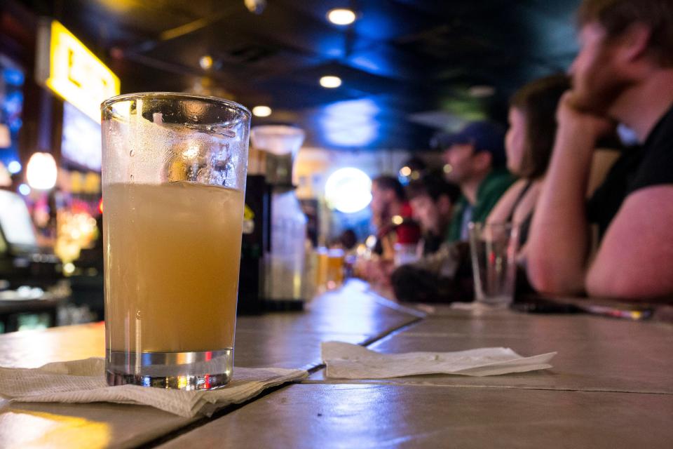 The bar starts to fill up around 9 p.m. at The Back Door on a Tuesday night.