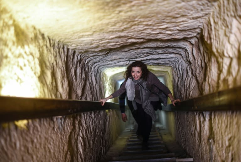 An Italian tourist walks through a Giza pyramid corridor in the Egypt on January 20, 2016