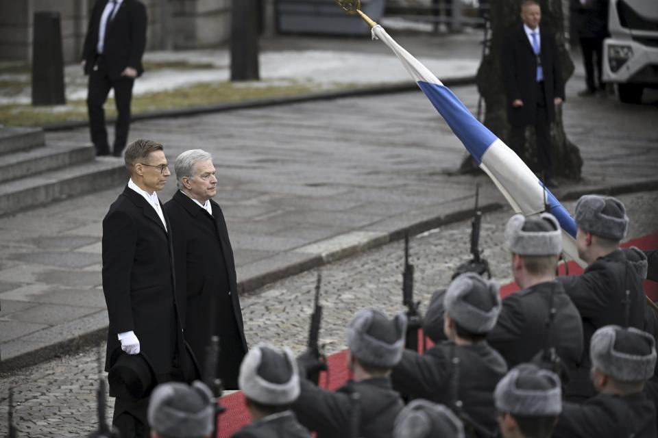 Incumbent President of the Republic of Finland Sauli Niinistö and President-elect Alexander Stubb, left, inspect the Guard of Honour before attending Parliament's plenary session during the inauguration of the President of the Republic of Finland in Helsinki, Finland, Friday March 1, 2024. (Antti Aimo-Koivisto/Lehtikuva via AP)
