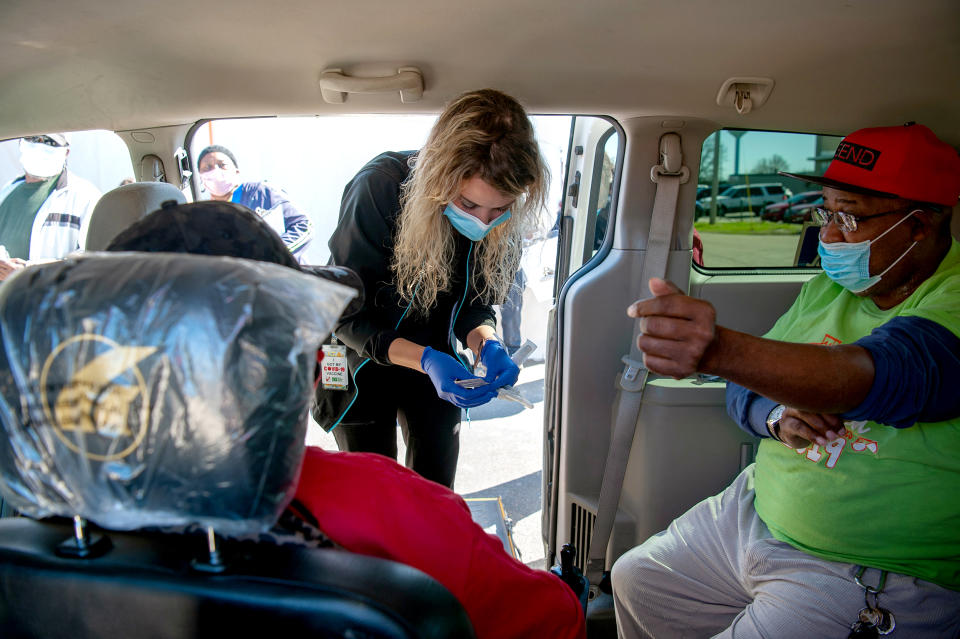 A healthcare worker arrives to administer a dose of the Moderna Covid-19 vaccine to people in a Vaccination Transportation Initiative sponsored van outside a medical clinic in Ruleville, Miss., on March 4, 2021. (Rory Doyle / Bloomberg via Getty Images file)