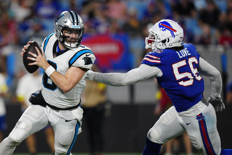 Carolina Panthers quarterback Baker Mayfield breaks away from Buffalo Bills defensive end Mike Love during the first half of an NFL preseason football game on Friday, Aug. 26, 2022, in Charlotte, N.C. (AP Photo/Jacob Kupferman)