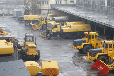 Snow ploughs are seen at Moscow's Vnukovo airport, October 21, 2014. REUTERS/Maxim Zmeyev