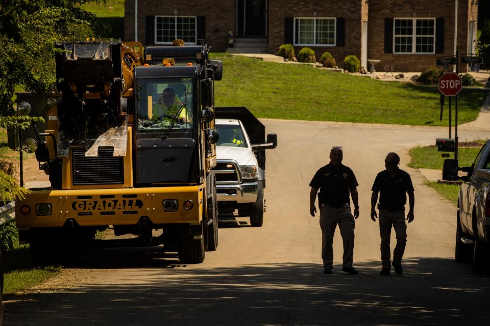 Nelson County Sheriff's Department deputies direct traffic in and out of the Bardstown subdivision where the FBI has taken the lead in Crystal Rogers missing persons case. Heavy duty equipment was brought in Thursday to help in the excavation of a driveway where the property may be linked to Rogers' former boyfriend, Brooks Houck. Aug. 26, 2021