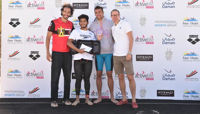 Omar Nour Chad, Le Clos and Sven Rohte COO Daman present Abu Dhabi Mile winner Al Balooshi with award.