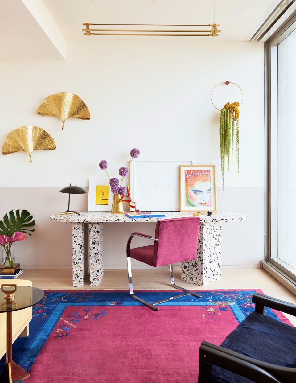 One of the home’s most eye-catching pieces is this custom desk, made of poured terrazzo and inset with bits of mirror and inspired by Miami in the 1980s. “We had seven or eight meetings about the desk,” says Angelo. “It was a true collaboration with us and Armann.” The fuchsia chair is a Mies van der Rohe Brno model, paired with a vintage Art Deco rug in matching colors.