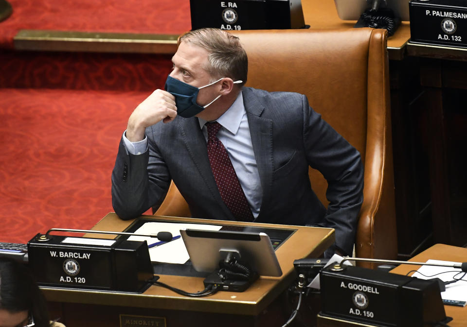 Assembly Minority Leader William A. Barclay, R- Fulton, watches the tote board for results as members explain their votes while debating budget bills during a Legislative session in the Assembly chamber at the state Capitol, Wednesday, April 7, 2021, in Albany, N.Y. (AP Photo/Hans Pennink)