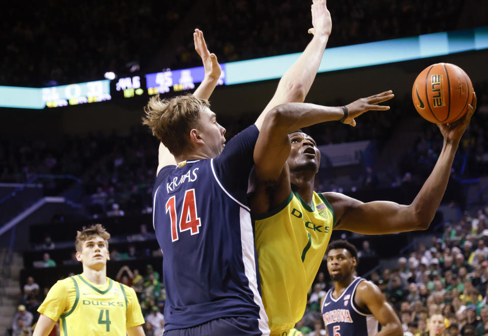 Oregon center N'Faly Dante (1), shoots against Arizona center Motiejus Krivas (14) during the first half of an NCAA college basketball game in Eugene, Ore., Saturday, Jan. 27, 2024. (AP Photo/Thomas Boyd)