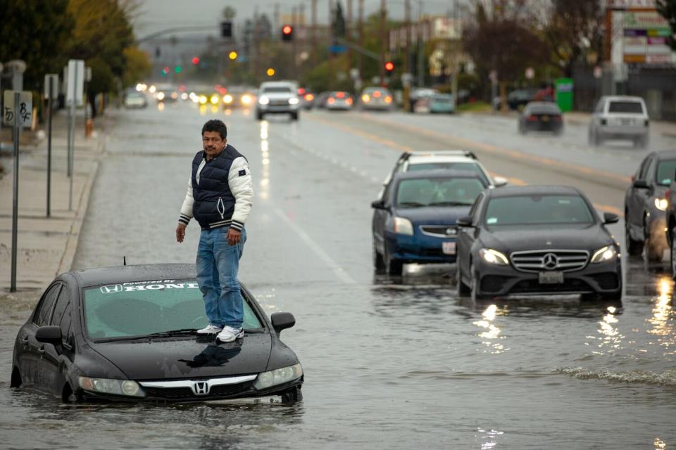 A driver who ignored road closure signs got stuck on flooded Vineland Avenue in North Hollywood.