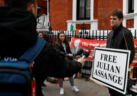 A supporter of WikiLeaks founder Julian Assange talks to the media, after Assange was arrested by British police, outside the Ecuadorian embassy in London, Britain, April 11, 2019. REUTERS/Peter Nicholls