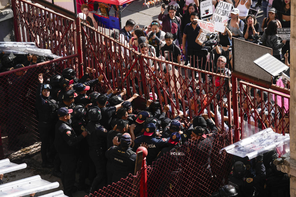 Police block a gate as animal rights activists try to enter the Plaza Mexico, in Mexico City, Sunday, Jan. 28, 2024. Bullfighting returned to Mexico City after the Supreme Court of Justice overturned a 2022 ban that prevented these events from taking place in the capital. (AP Photo/Fernando Llano)