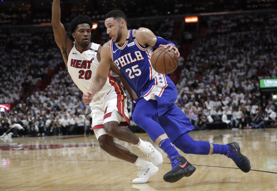 Philadelphia 76ers’ Ben Simmons (25) drives as Miami Heat’s Justise Winslow (20) defends during the first half of Game 3 of a first-round NBA basketball playoff series, Thursday, April 19, 2018, in Miami. (AP Photo/Lynne Sladky)