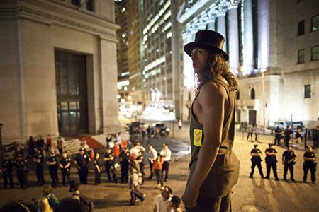 An Occupy Wall Street protester stands on the steps of Federal Hall, across the street from the New York Stock Exchange in New York in this April 16, 2012 file photo. REUTERS/Andrew Burton/Files