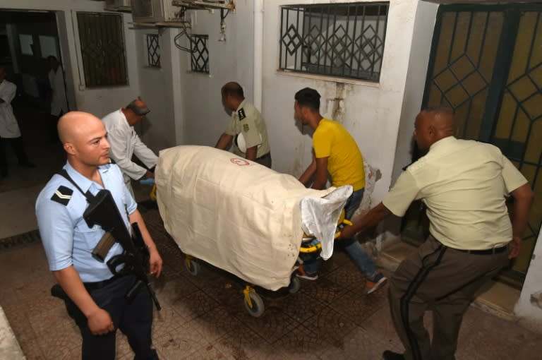 Hospital personnel and colleagues of a Tunisian member of the security forces killed in a landmine ambush in the Jenduba border province, transport his body hospital in the capital Tunis on July 8, 2018