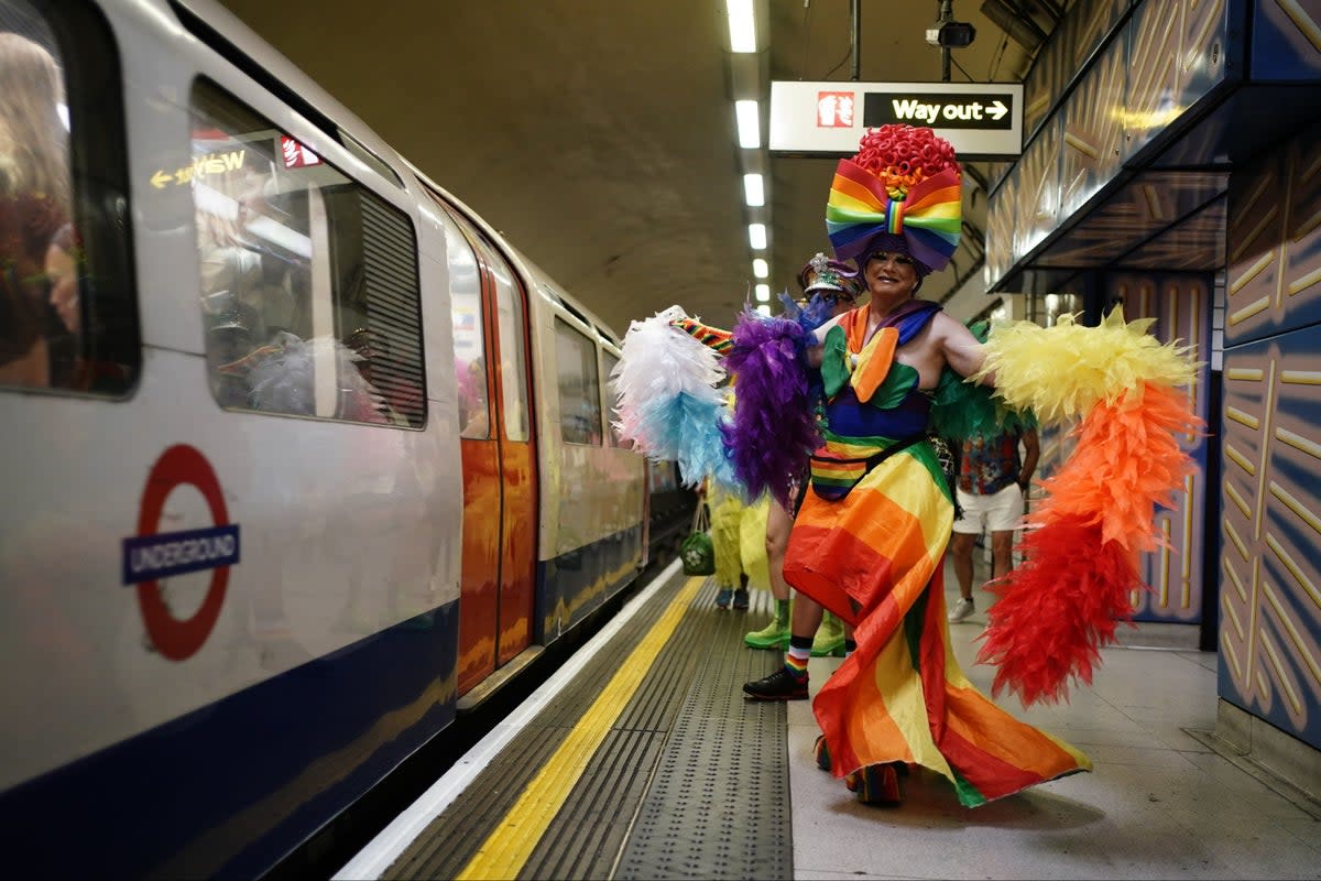 People at Leicester Square underground station as they head to Hyde Park to take part in the Pride in London parade last year (PA)