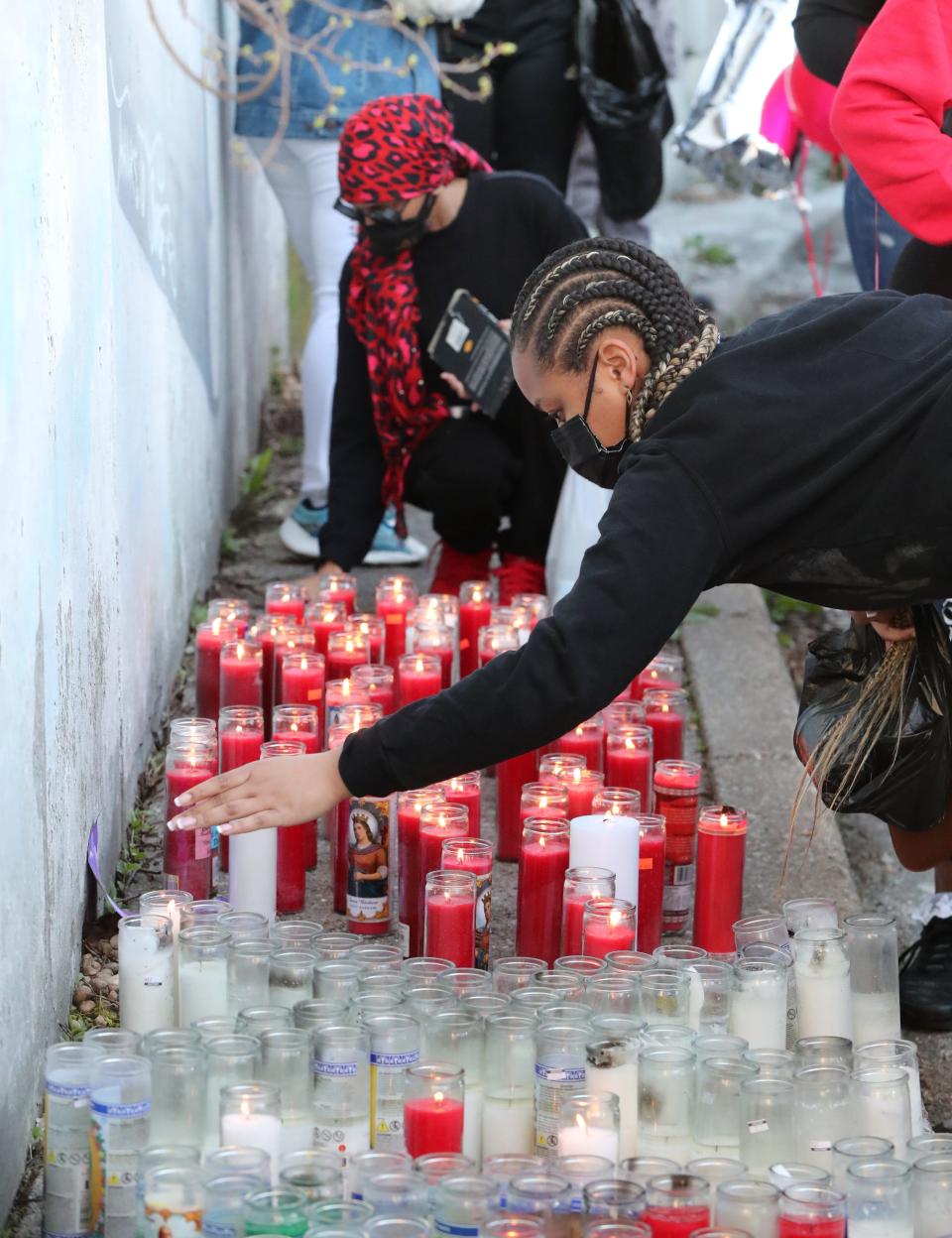 People place candles during a vigil for DMX where he grew up, on School Street in Yonkers April 13, 2021.