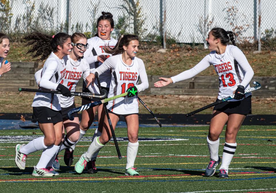 Mamaroneck celebrates after Audrey Adorno, left, scored against Orchard Park during the New York State Class A Field Hockey championship at Centereach High School on Long Island Nov. 12, 2023. Mamaroneck defeated Orchard Park 4-0 to win the state championship.