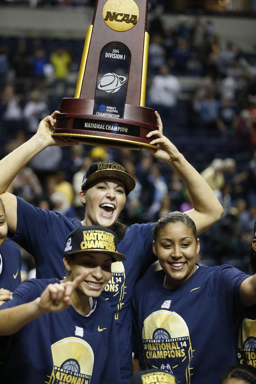 Connecticut center Stefanie Dolson (31) and team members celebrate with the championship trophy after the second half of the championship game against Notre Dame in the Final Four of the NCAA women's college basketball tournament, Tuesday, April 8, 2014, in Nashville, Tenn. Connecticut won 79-58. (AP Photo/John Bazemore)