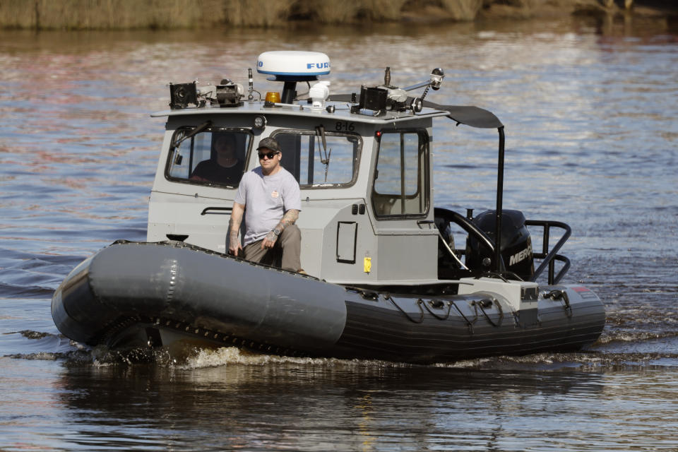 A Navy boat navigates the InterCoastal Waterway in North Myrtle Beach, S.C., Tuesday, Feb. 7, 2023. Using underwater drones, warships and inflatable vessels, the Navy is carrying out an extensive operation to gather all of the pieces of the massive Chinese spy balloon a U.S. fighter jet shot down off the coast of South Carolina on Saturday. (AP Photo/Nell Redmond)