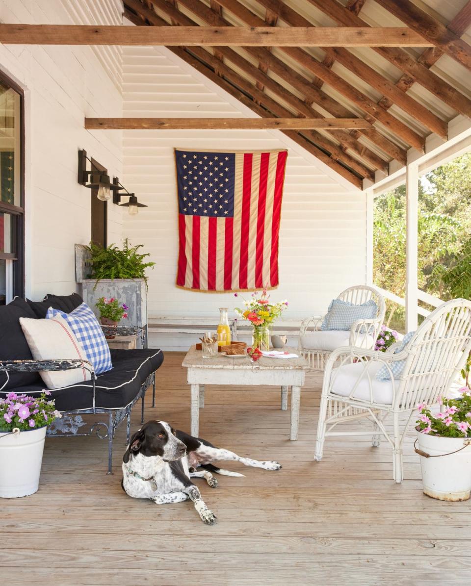 a dog relaxing outside saltbox hill country farmhouse in la grange, texas